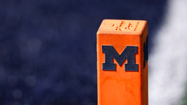A Michigan logo on a football pylon.