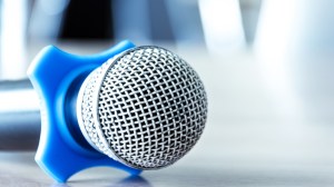 A microphone rests on a table before a media outing.