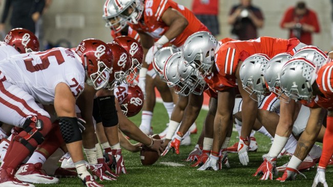 Ohio State and Oklahoma players face off at the line of scrimmage.
