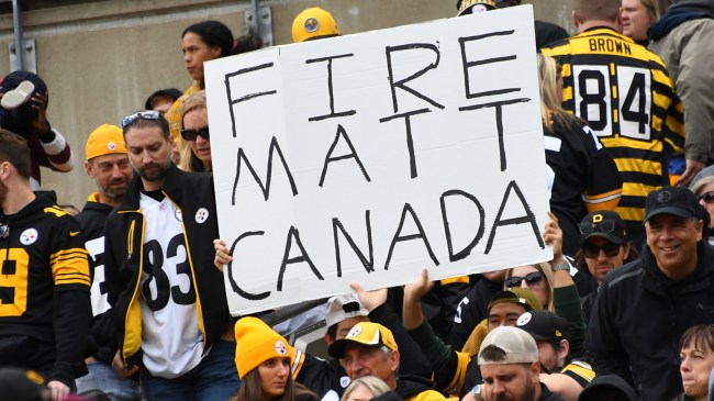A Steelers fan holds up a "Fire Matt Canada" sign in the stands.