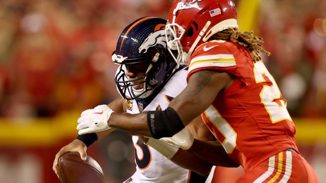 Russell Wilson is tackled by a Kansas City Chiefs defender.