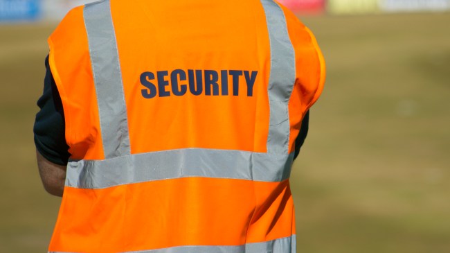 A security guard watches the field during a sporting event.