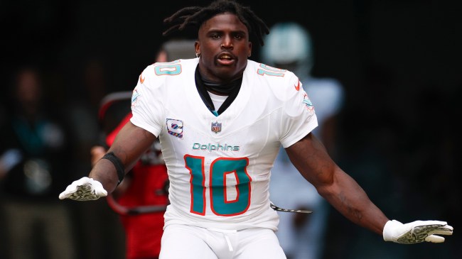 Tyreek Hill runs onto the field before a Dolphins game.