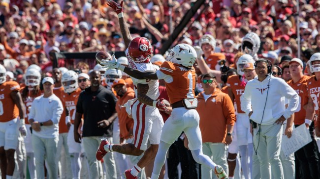 Xavier Worthy tries to make a contested catch in a game between Texas and Oklahoma.