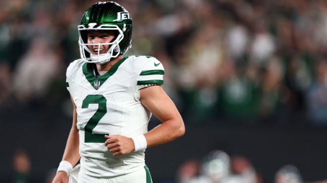 zach wilson in a white jets jersey