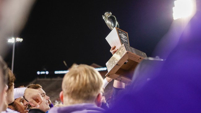 Washington players hoist the Apple Cup after beating Washington State in its annual rivalry.