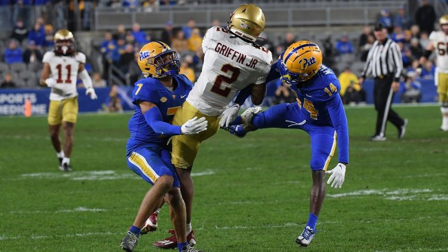 A Boston College receiver hauls in a pass over Pitt defenders.