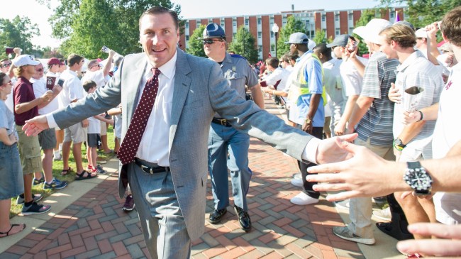 Dan Mullen walks to the stadium before a game at Mississippi State.