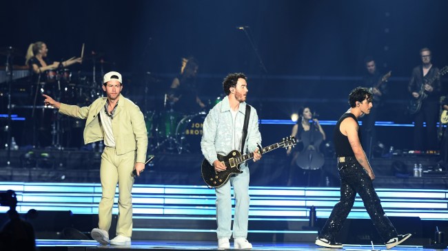 The Jonas Brothers perform on stage.