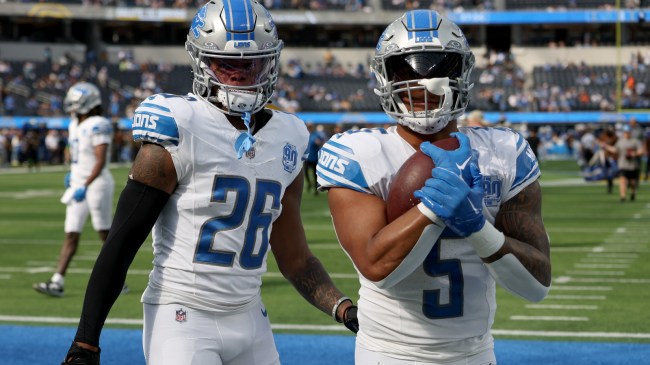 Jahmyr Gibbs and David Montgomery warm up before a game.