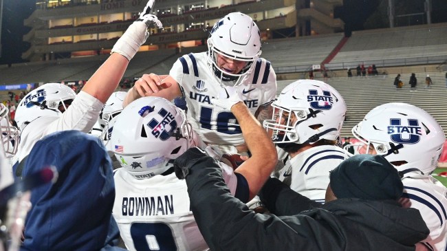 Utah State players carry Levi Williams off the field after an overtime win.
