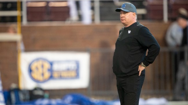 Mark Stoops on the field before a game between Kentucky and Mississippi State.