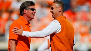 Mike Gundy and Steve Sarkisian shake hands before a game between Texas and Oklahoma State.