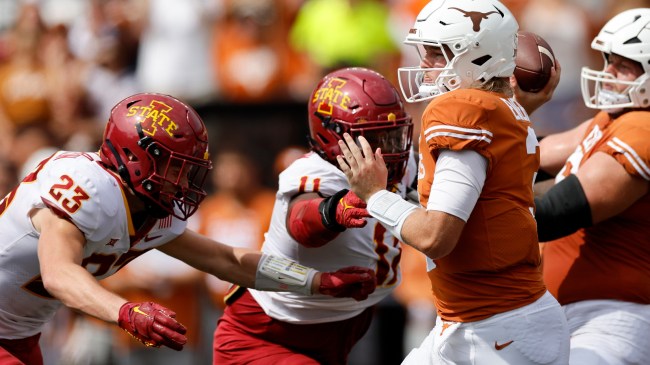 Texas QB Quinn Ewers looks to throw as Iowa State defenders close in.