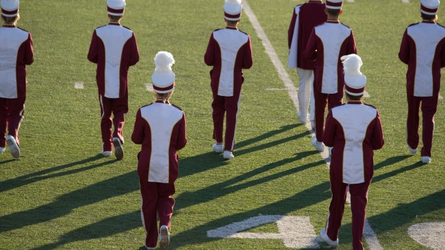 Band members walk onto the field during the halftime performance.