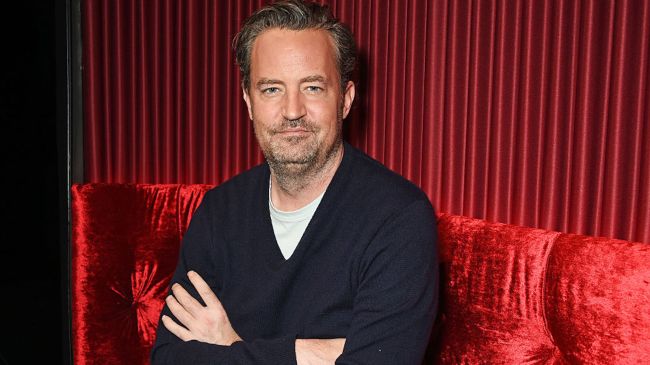 matthew perry on a red couch