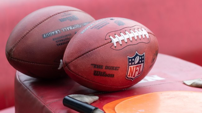 Two footballs on the sidelines before an NFL game.