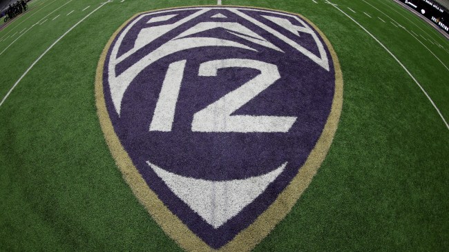 A PAC 12 logo on the field during a game between Washington and Washington State.