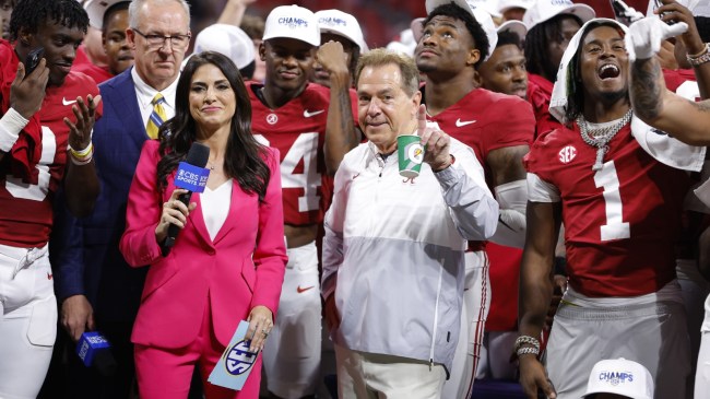 Nick Saban poses for a photo with the Alabama team after an SEC Championship win.