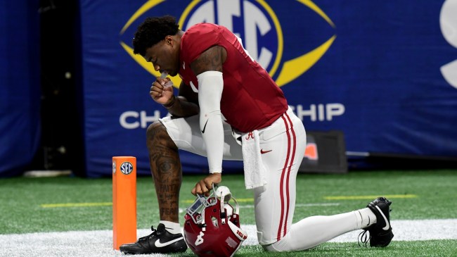 Jalen Milroe kneels in the endzone before the SEC Championship Game.