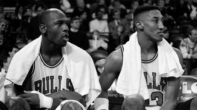 Michael Jordan and Scottie Pippen sit on bench during Bulls game