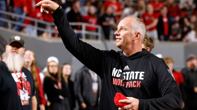 Dave Doeren interacts with the crowd after an NC State football game.