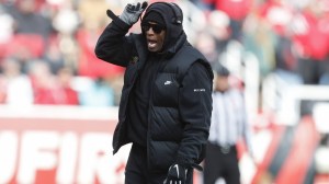 Deion Sanders calls in a play from the sidelines.