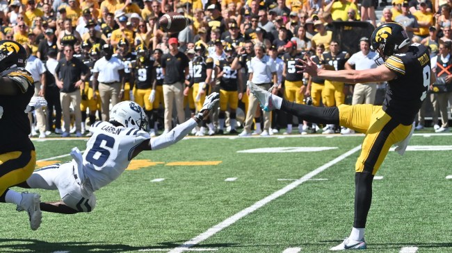 Iowa's Tory Taylor punts the ball against Utah State.