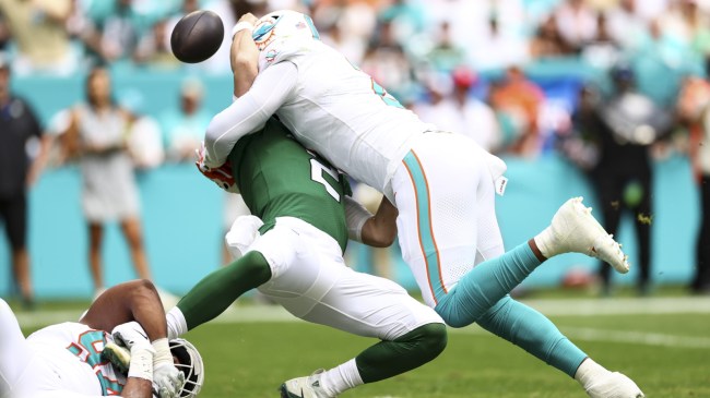 Zach Wilson is sacked by a Dolphins defensive lineman.