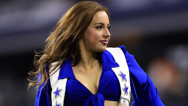 A Dallas Cowboys cheerleader on the field during a game.