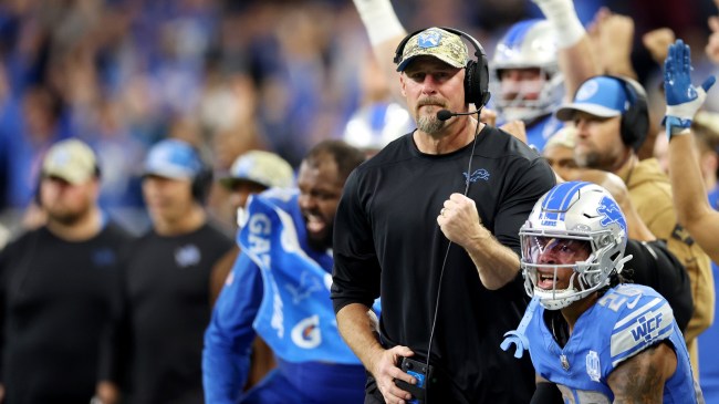 Head coach Dan Campbell celebrates with his Detroit Lions team on the sidelines.