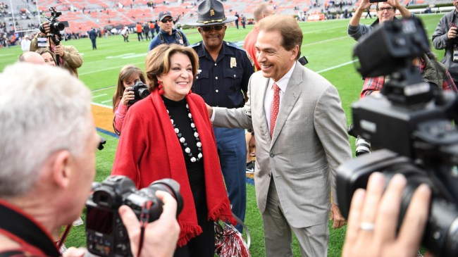 Nick Saban and wife, Terry, on the field after an Alabama football game.