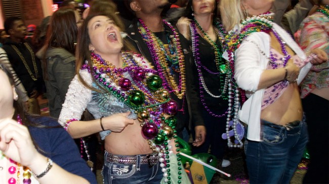 Revelers party on Bourbon Street in the French Quarter during Mardi Gras