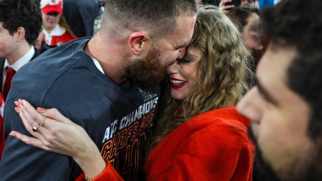 Travis Kelce and Taylor Swift celebrate on the field after the AFC Championship.
