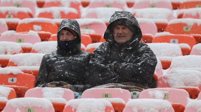 nfl fans sitting in the snow