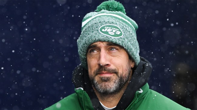 Aaron Rodgers of the New York Jets runs onto the field in snow