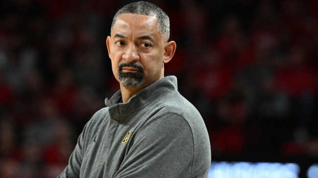 Juwan Howard coaches from the bench during a Michigan basketball game.