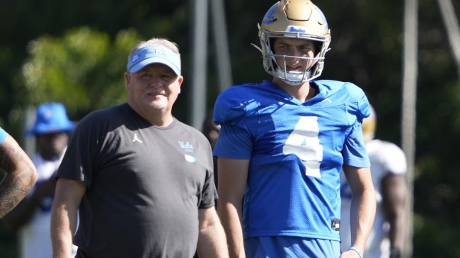 Ethan Garbers at UCLA football practice next to head coach Chip Kelly.