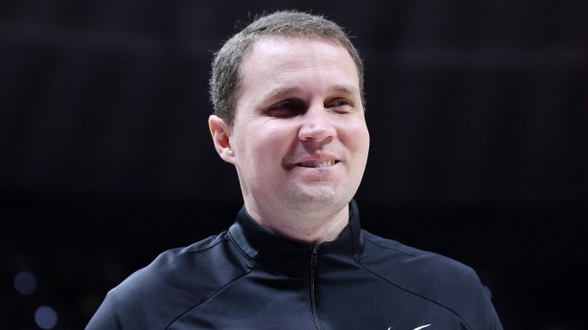 Will Wade smiles while coaching an LSU basketball game.