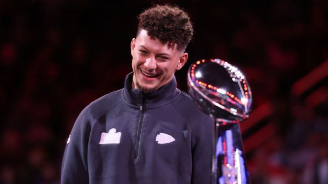 patrick mahomes smiling at the vince lombardi trophy