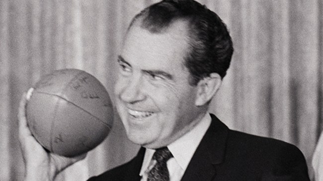 Richard Nixon holding a football