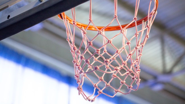 A view of the net from below the basketball rim.