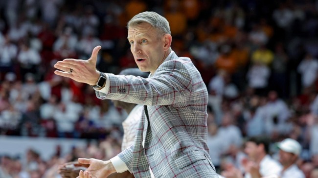 Alabama head basketball coach Nate Oats communicates to his team from the bench.