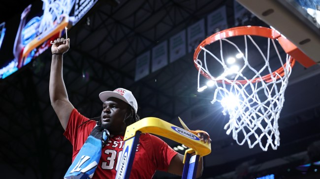 DJ Burns cuts down the net after NC State books a ticket to the Final Four.