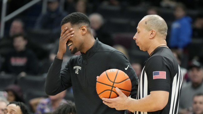 Providence head basketball coach Kim English reacts to a play on the sidelines.