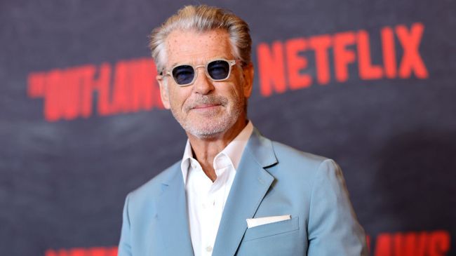 pierce brosnan wearing a blue suit and sunglasses