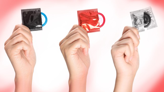 women holding colored condoms