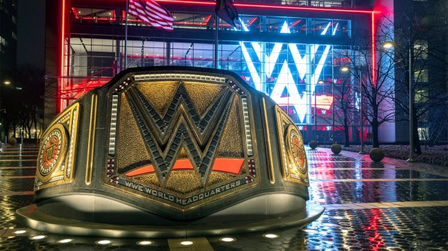 wrestling belt stands in front of the WWE wrestling world headquarters