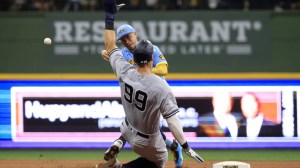 Aaron Judge slides into second base during a game between the Yankees and Brewers.