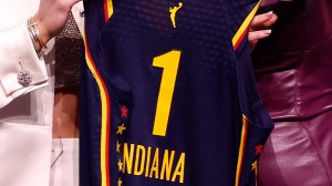 Caitlin Clark holds Indiana Fever jersey with WNBA Commissioner Cathy Engelbert